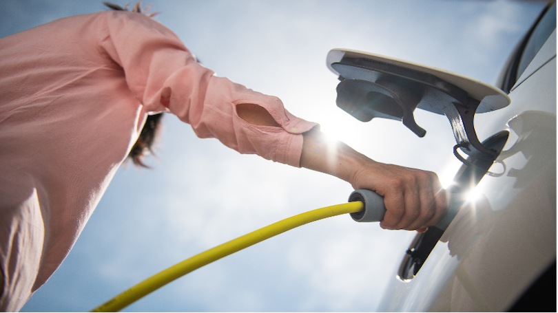 Image of person pumping gas