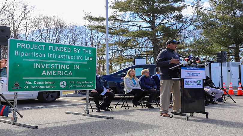 Opening ceremony for Maine NEVI station taking place near wooded area. 