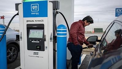 Man charging vehicle.