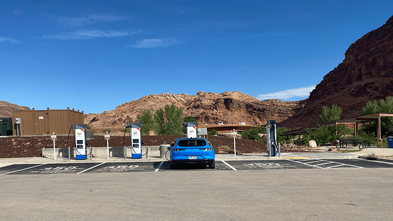 First NEVI station opens in Utah. Blue car charging.