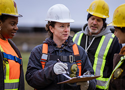 workers with hard hats and safety vests